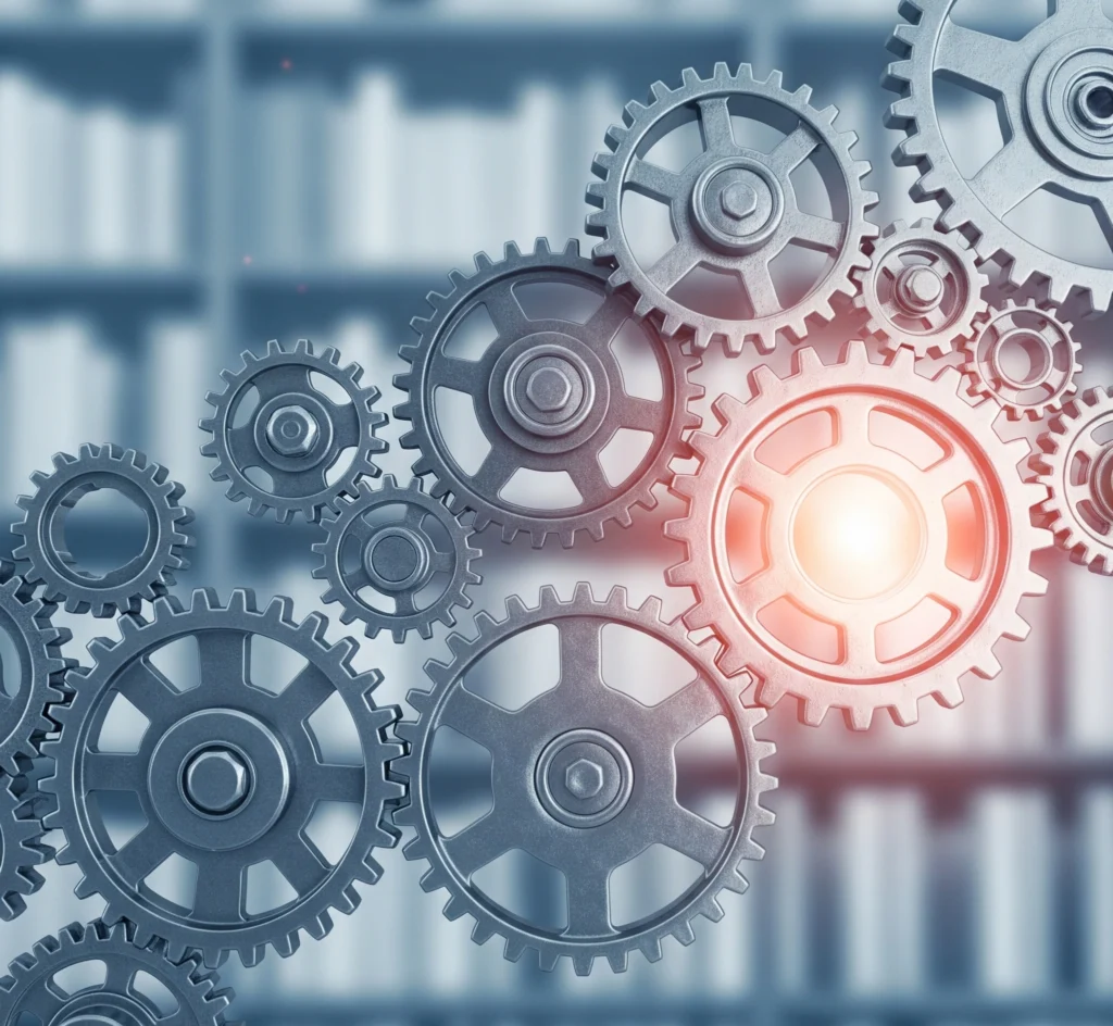 Metaphorical image of interconnected gears smoothly turning, representing a well-managed scholarship application process, controlled by a proactive student.